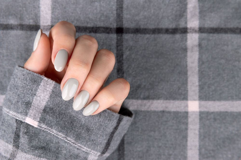 beautiful-womans-hand-with-manicure-checkered-shirt